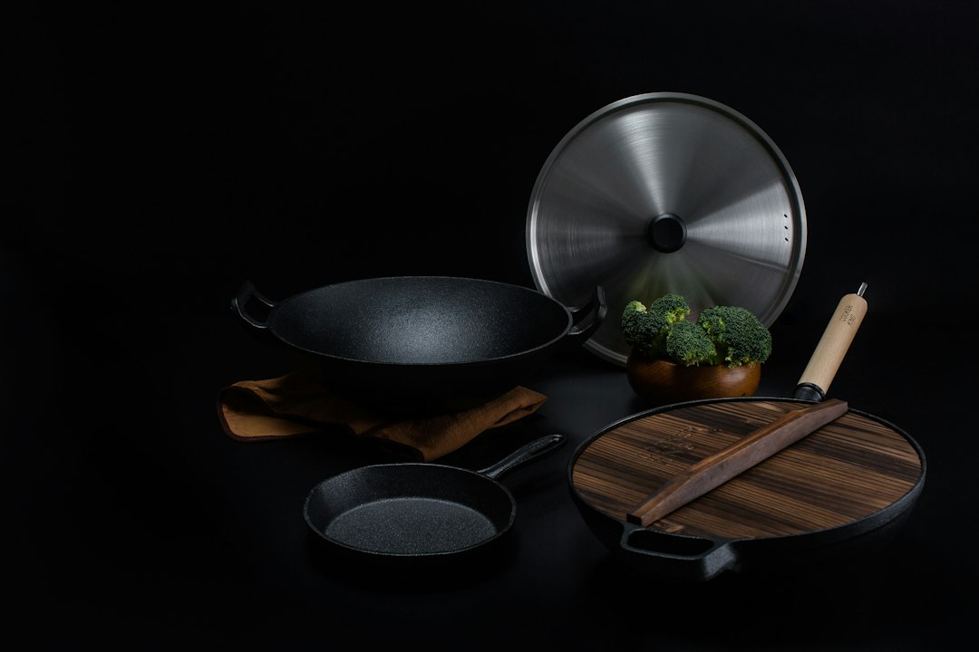 brown wooden handled stainless steel cooking pan